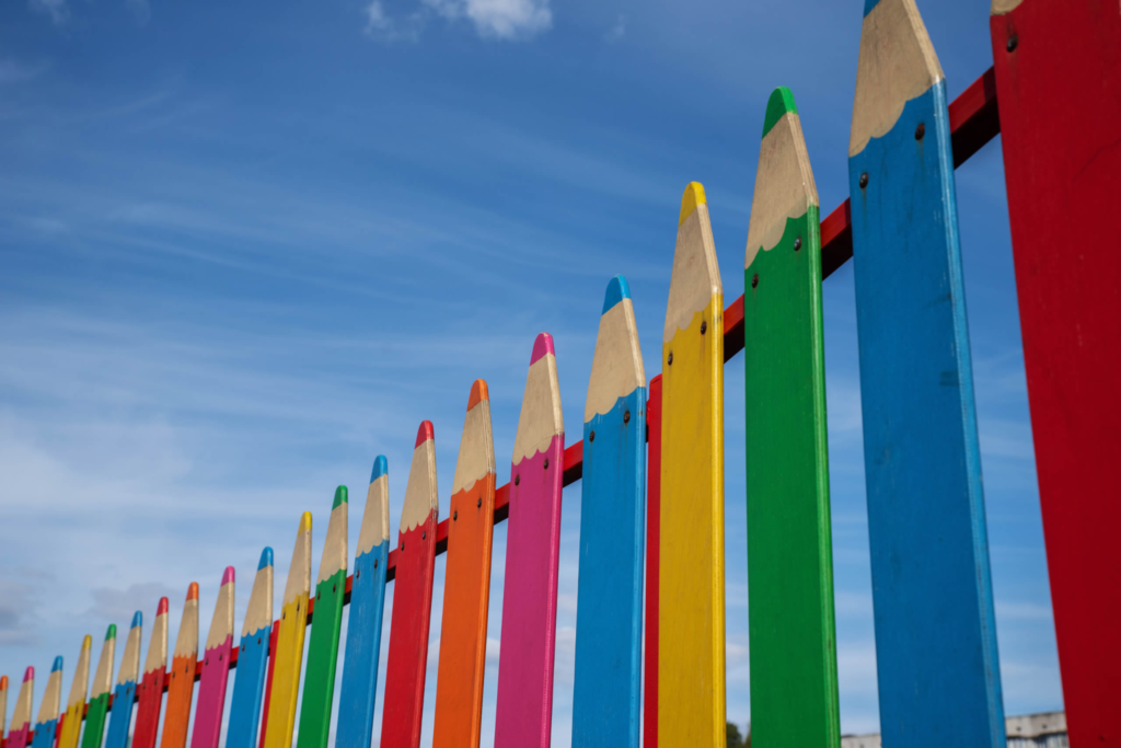 Colourful pencil-shaped playground fence